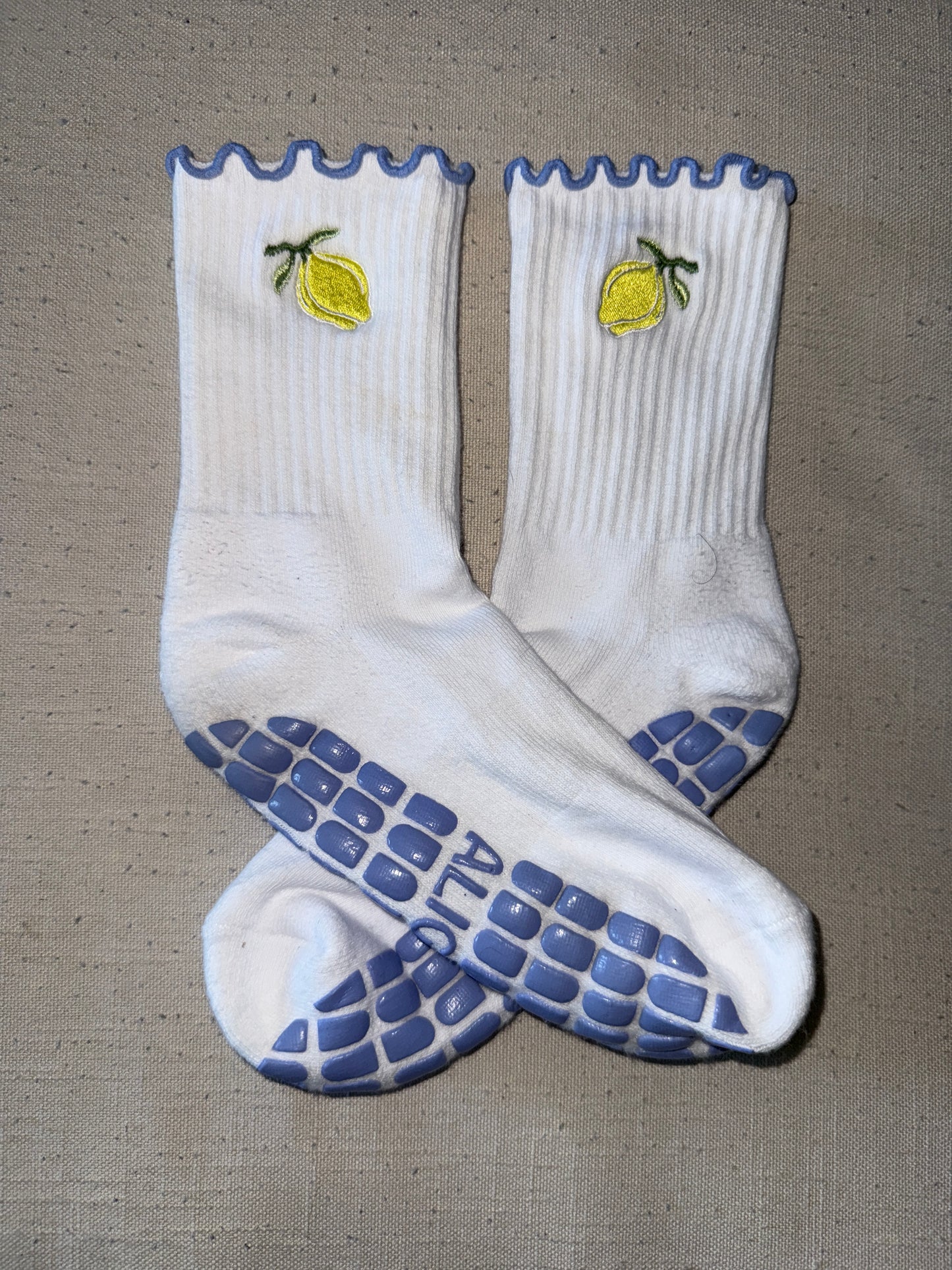 Close up photo of white and blue trim Santorini non slip grips socks while