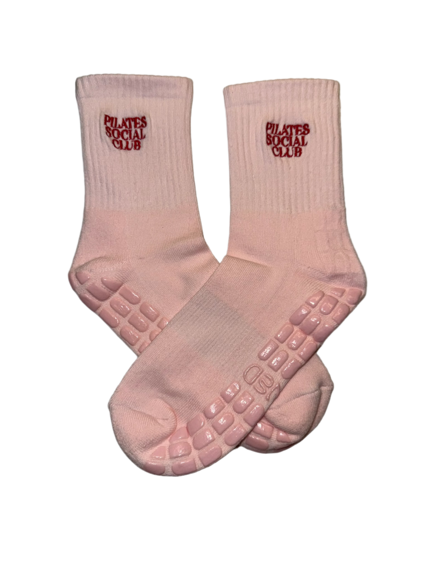 Pink grip socks with embroidered writing "pilates social club"
